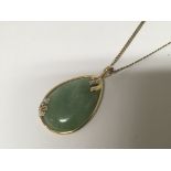 A 14carat gold and jade pendent on a 9carat gold n