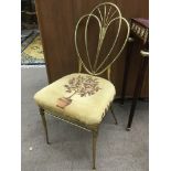 An Italian brass framed chair with upholstered seat.