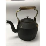 A heavy Victorian cast iron kettle with brass hand