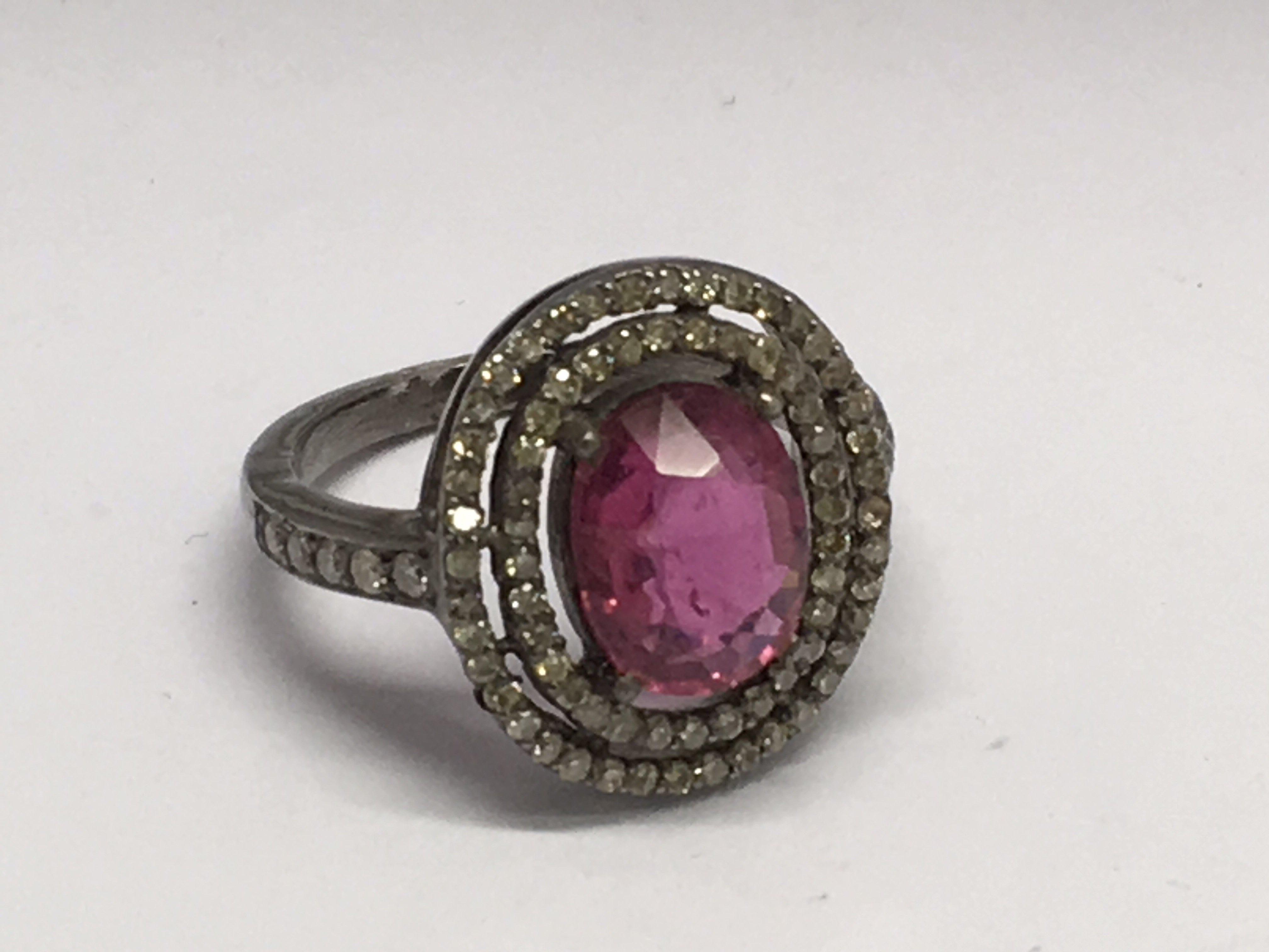 A diamond and pink tourmaline cluster ring, approx