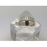A three row channel set diamond ring in 14ct gold,