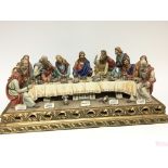A large Capodimonte ceramic figure group of the last supper on a gilt scroll base signed. 63x30cm.
