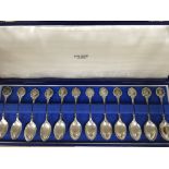 A cased set of 12 silver tea spoons the Roman spoo