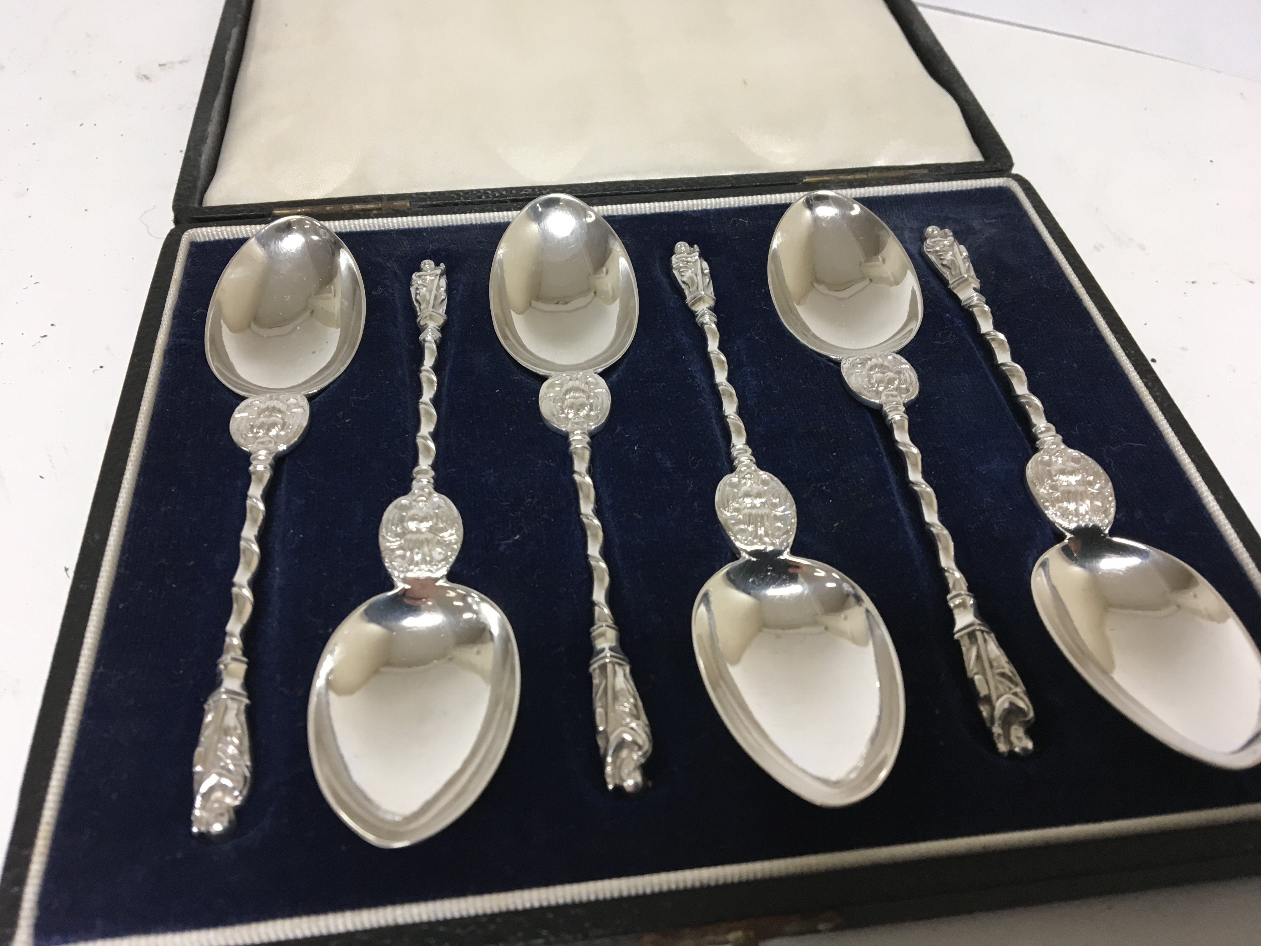 A cased set of Quality Victorian silver apostle spoons with shaped stems maker Henry Holland