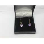 A pair of 9ct gold and amethyst drop earrings, app
