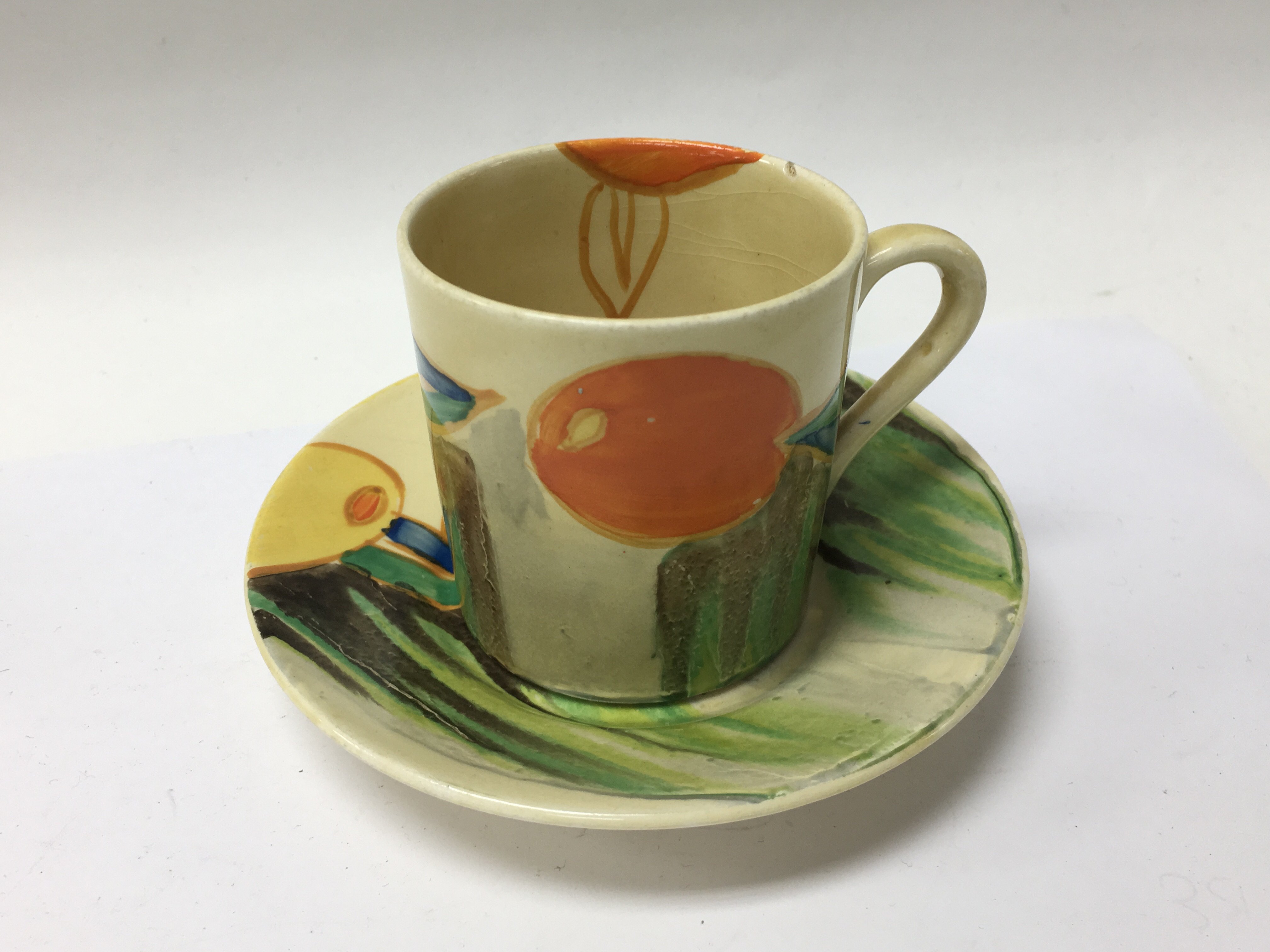 A Clarice Cliff coffee can and saucer decorated in