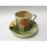 A Clarice Cliff coffee can and saucer decorated in