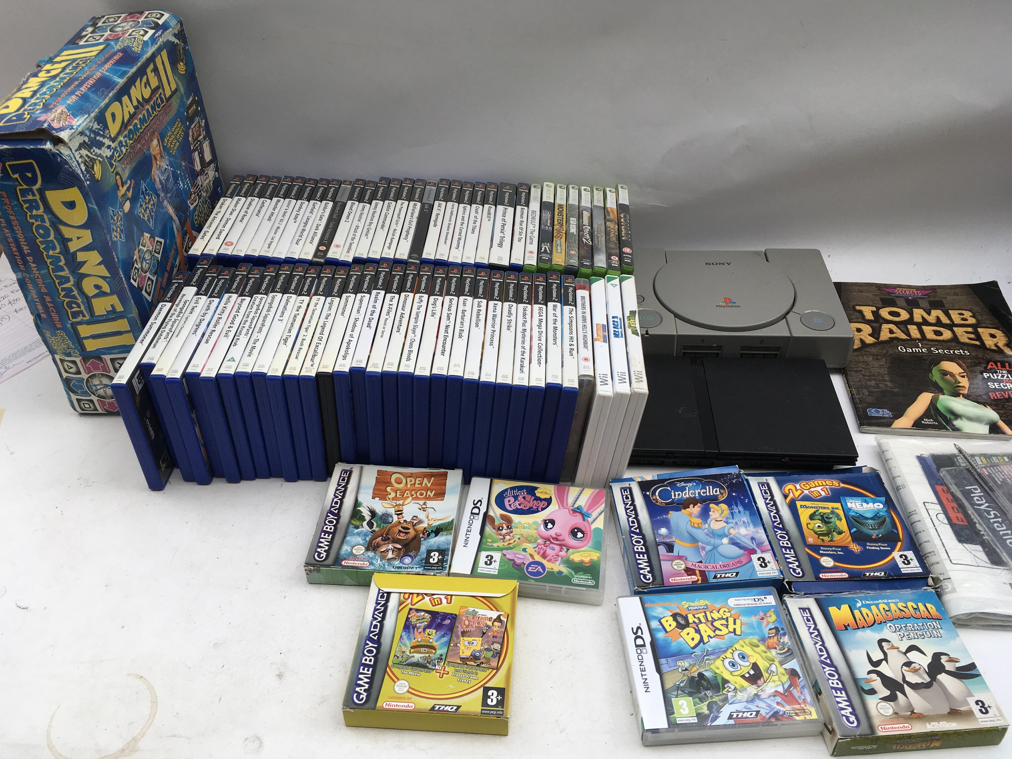 A box of PlayStation, Xbox, Gameboy advance and Ni