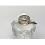 A 9ct white gold multi stone bombe pave set ring,