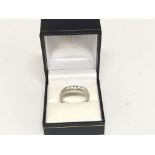 An 18carat white gold half hoop eternity ring set