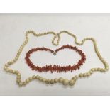 An ivory bead necklace and a coral example (2) - N