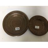 Two Middle Eastern copper trays of circular shape with hammered decoration. (2)
