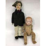 A German bisque headed doll and a male composite d