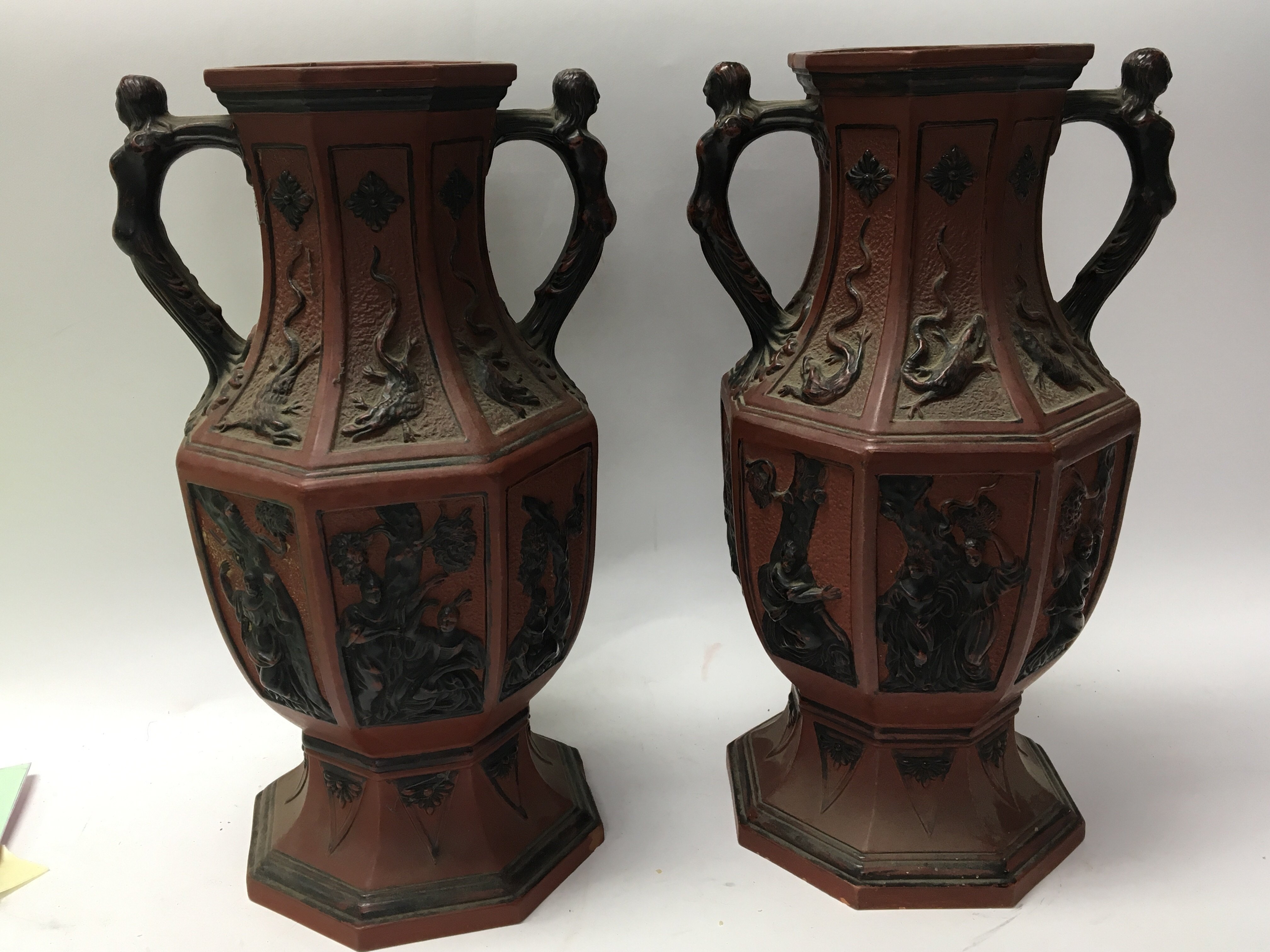 A pair of Terracotta oriental style vases decorate