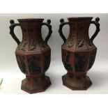 A pair of Terracotta oriental style vases decorate