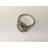 A 9 ct gold ring inset with opal size P