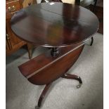 A mahogany, folding twin top table.Approx 55cm diameter x78cm high