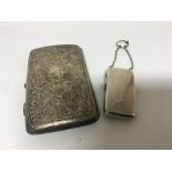 A silver cigar case with scroll decoration and par