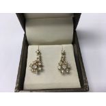A pair of 18 ct snowflake earrings inset with diam