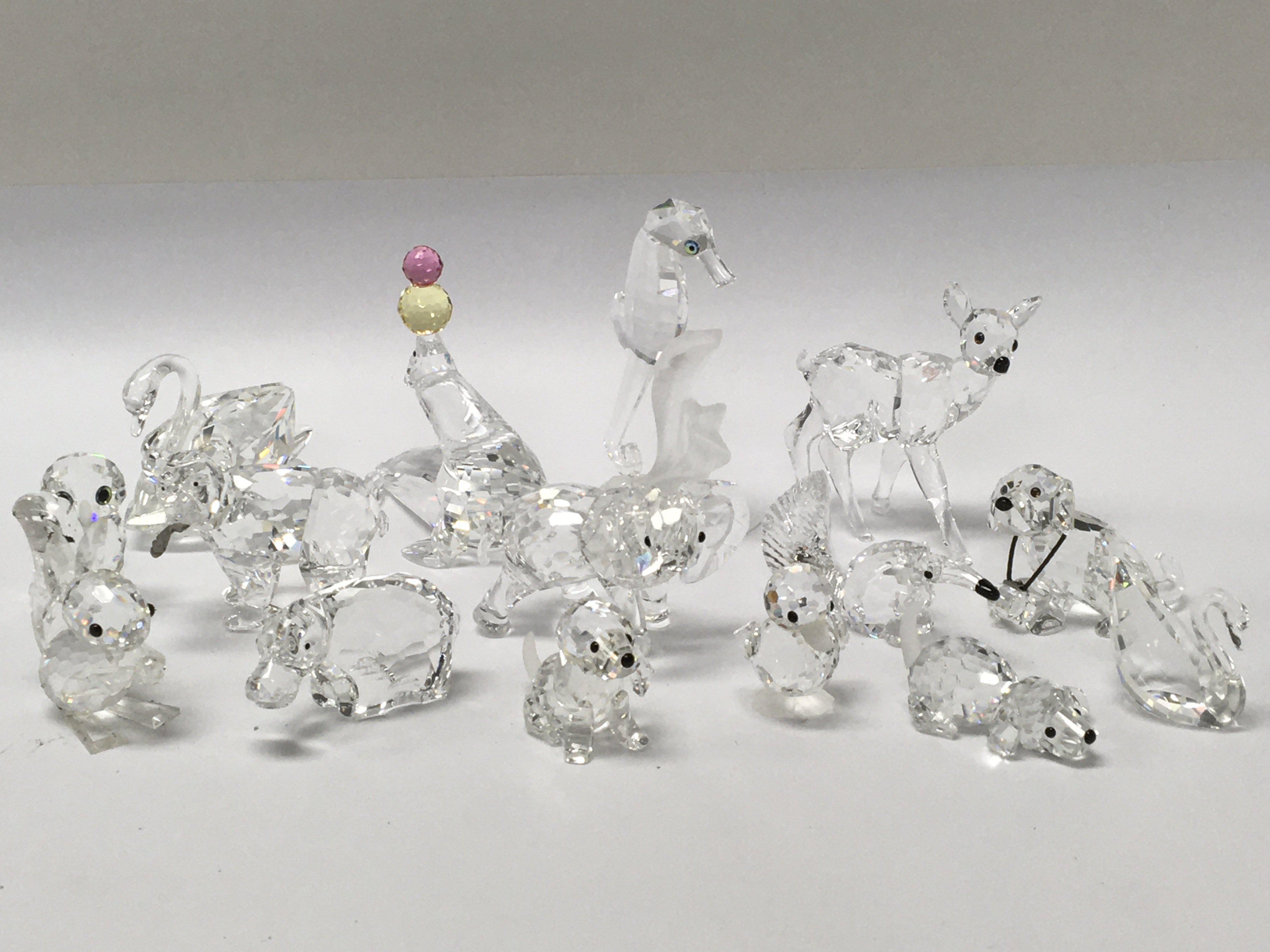 A collection of Swarovski animals, all with boxes,