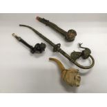 Four smoker's pipes comprising an ornate example w