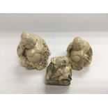 Three ivory buddhas including one netsuke.