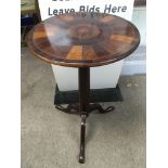 A circular side table with an inlaid top, approx 7