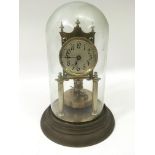A brass skeleton clock under glass dome.Approx 30c