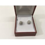 A pair of 9ct white gold earrings set with chips,