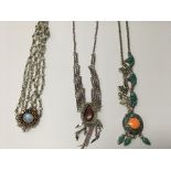 A collection of three decorative silver necklaces