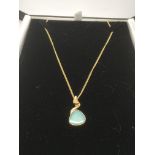 A 9ct gold chain with an opal pendant in a 9ct gol