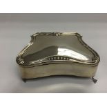 A silver jewel box raised on splayed feet, approx