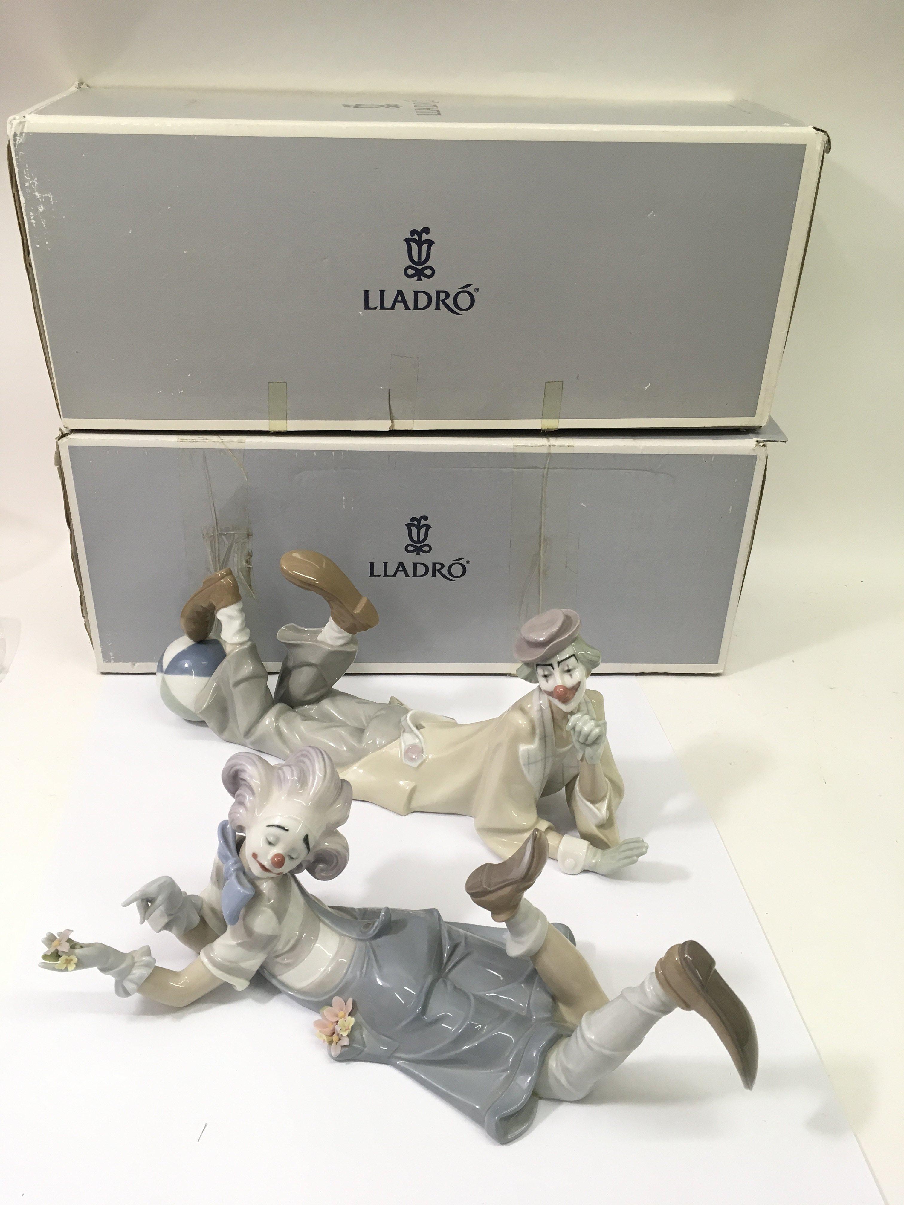 A pair of large Lladro boy and girl clowns, boxed.