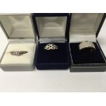 Three gold rings including diamond inset