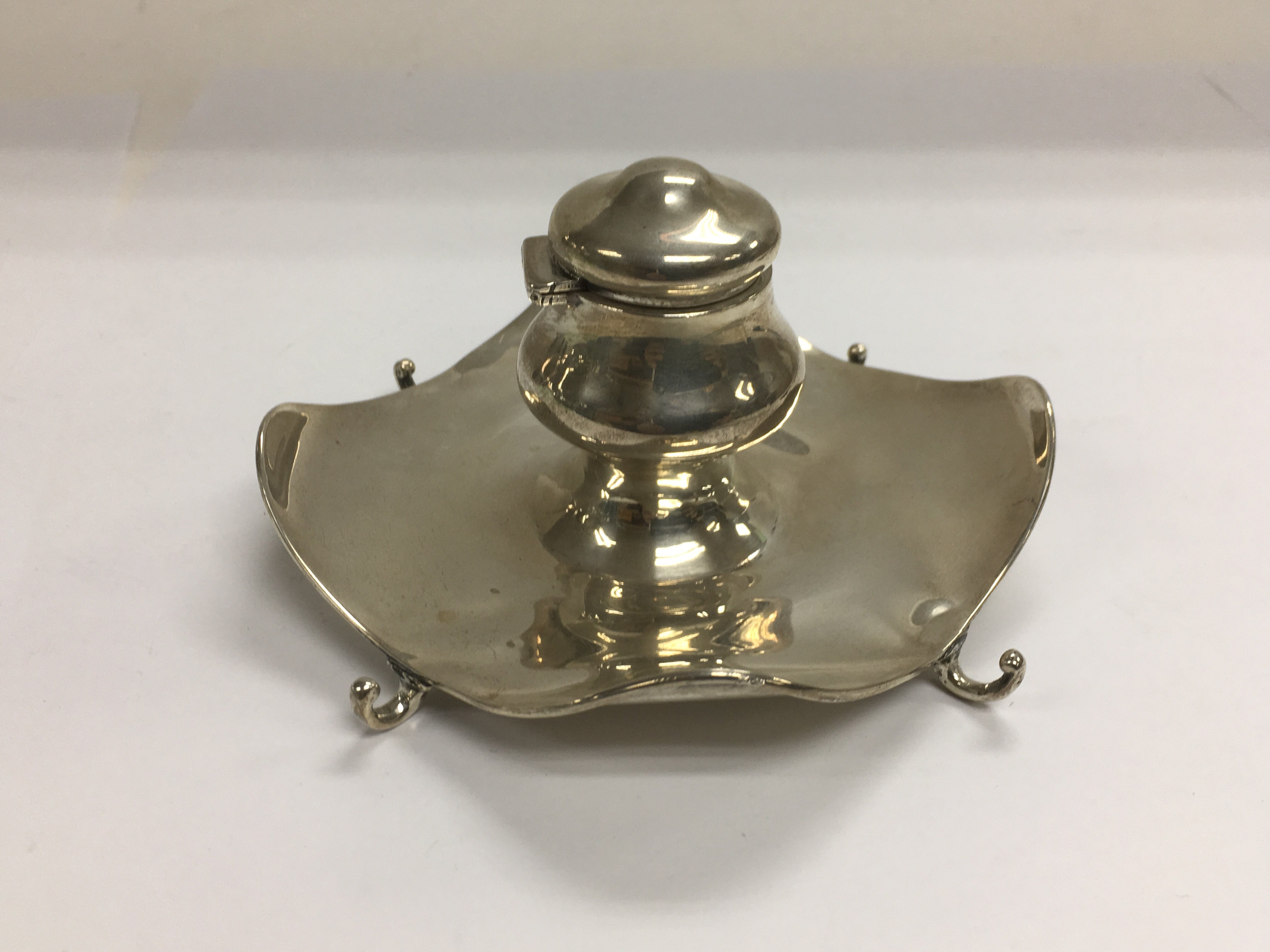 An Edwardian silver ink stand complete with clear