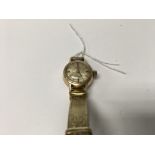 A ladies 9 ct gold omega watch with gold plated strap