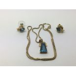 A 9ct gold chain with a blue sapphire pendant and
