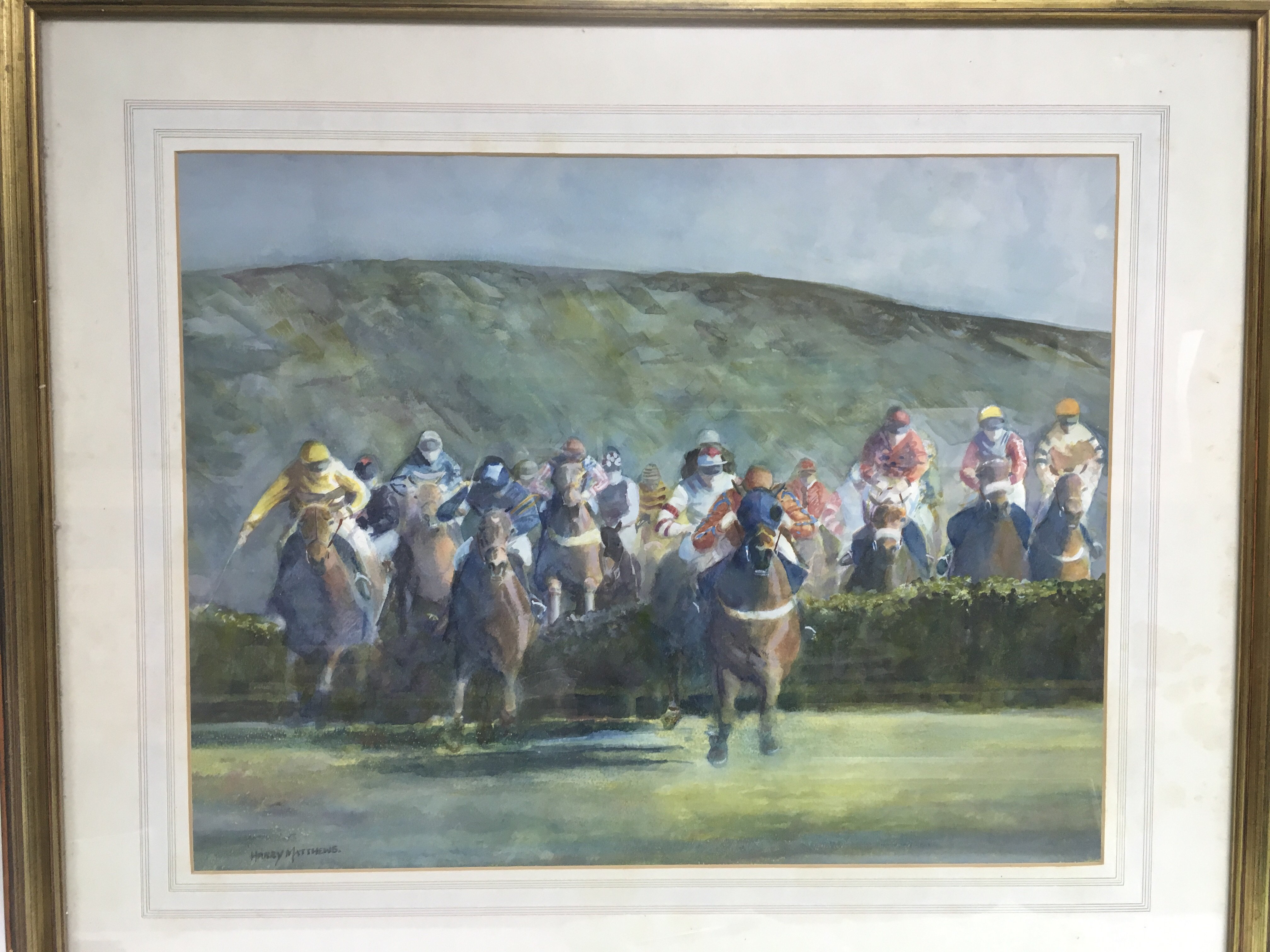 A framed and glazed watercolour of horse racing by Harry Matthews, approx 8cm x 69.5cm.