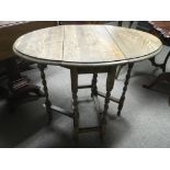 An oak gateleg table with barley twist legs, appro