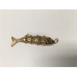 A 9ct gold charm in the form of a articulated fish