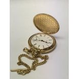 A gold plated hunter button wind pocket watch and