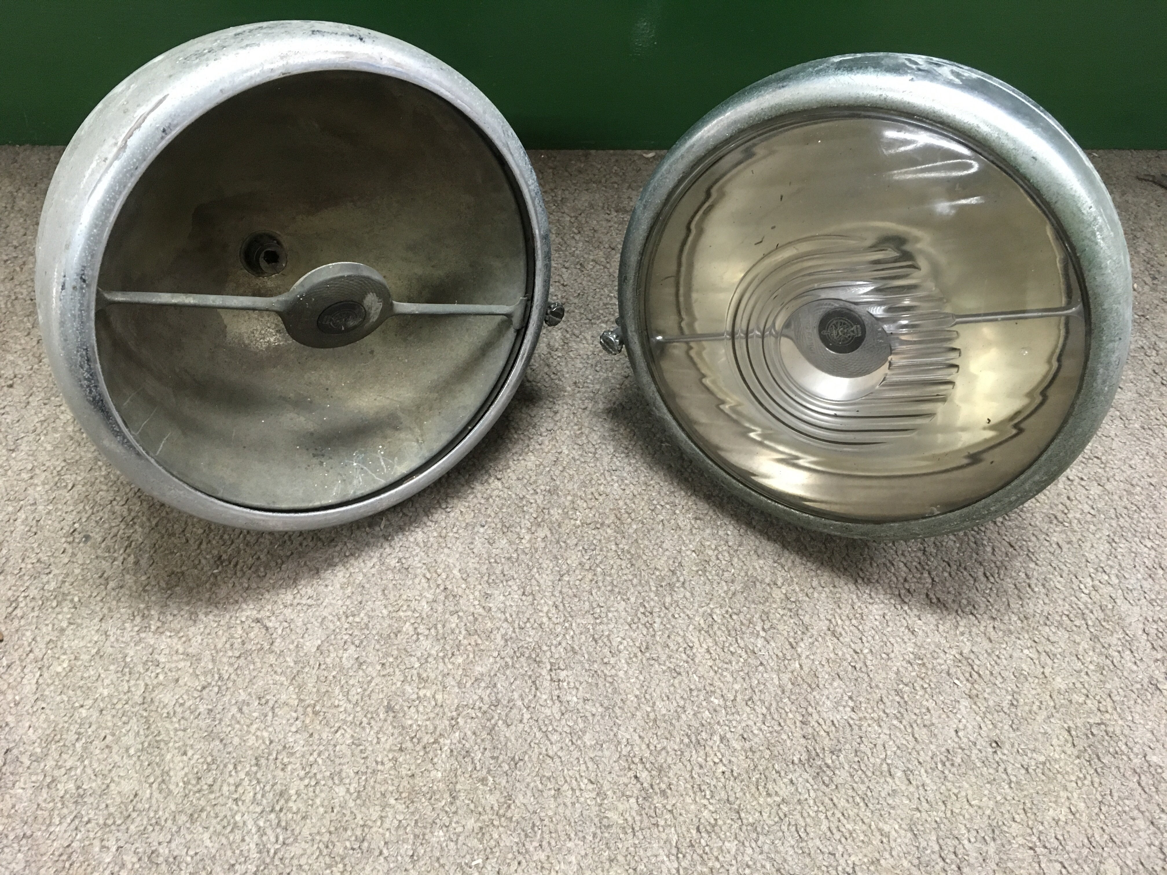 A pair vintage Jaguar car sports headlights, one l