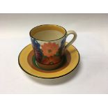 A Clarice Cliff coffee can and saucer in the gay d