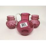 A pair of late Victorian cranberry glass vases and