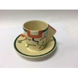 A Clarice Cliff coffee can and saucer decorated in
