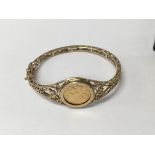 A 9 ct gold bangle inset with a 1982 sovereign 17