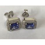 A pair of stud earrings inset with tanzanite