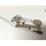 A collection of silver jewellery a locket and chai