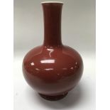 A Chinese bottle vase having a red glazz and seal mark to base 24 cm