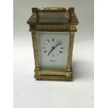 A brass cased carriage clock the enamel dial with